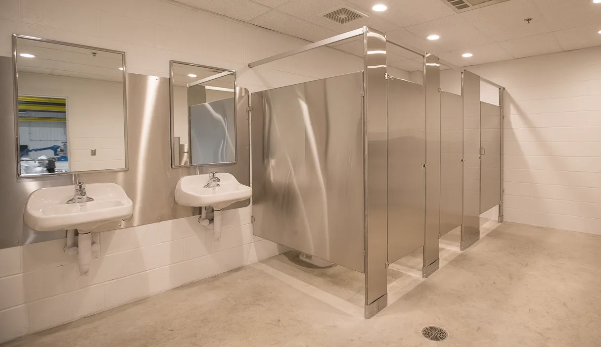 Bathroom with stalls, sinks, and mirrors